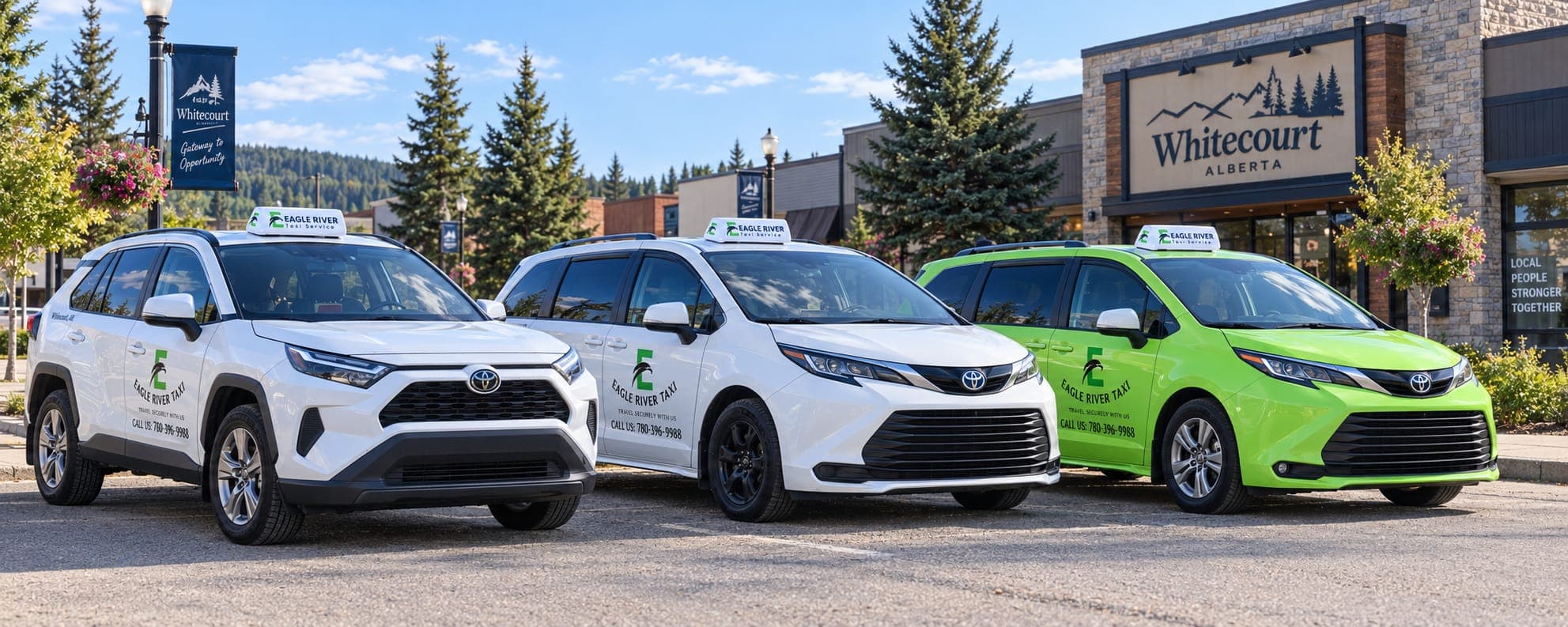 White and green Eagle River Cabs vehicles near a Whitecourt sign.